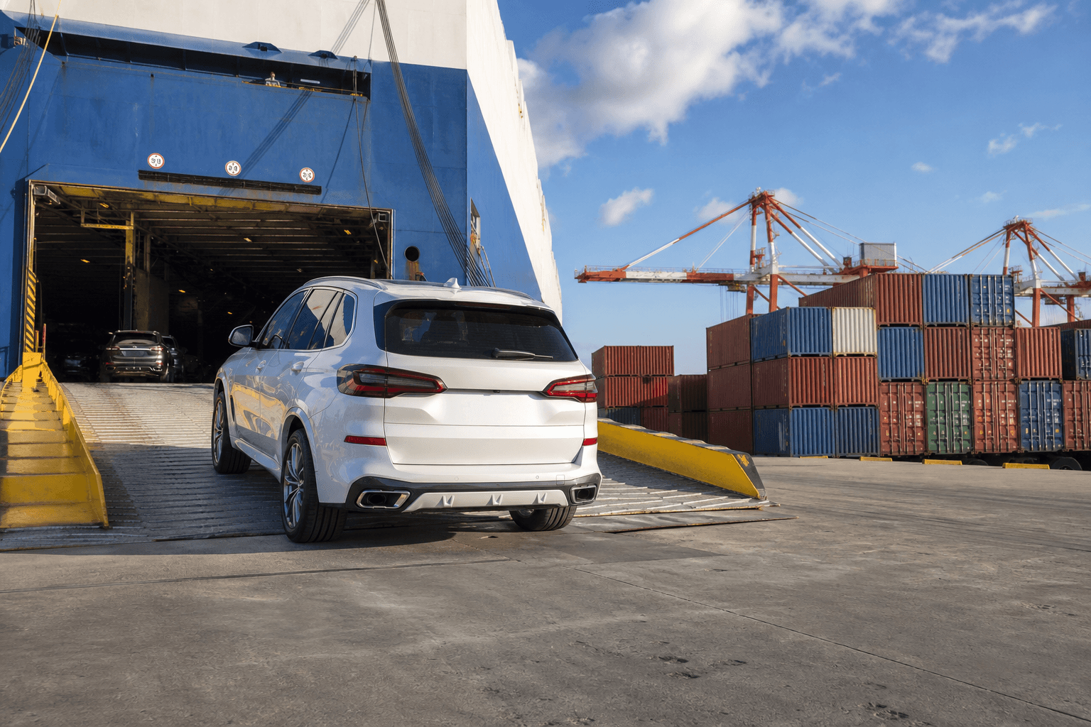 Véhicule embarqué sur un navire roulier avec conteneurs au port